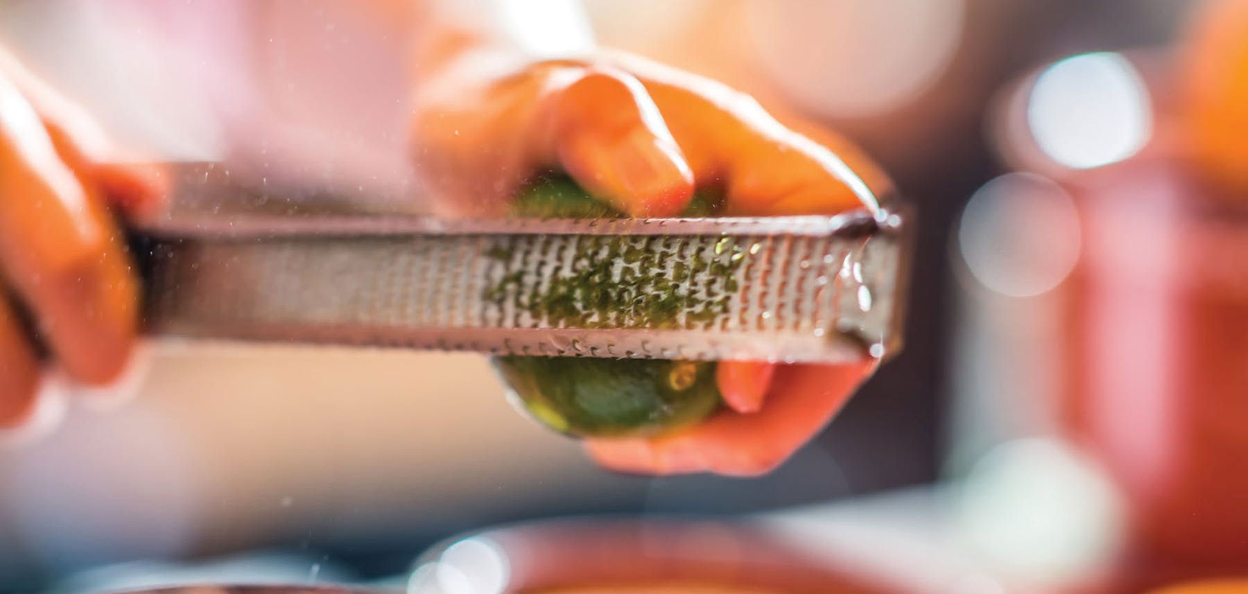 A man zesting a lime