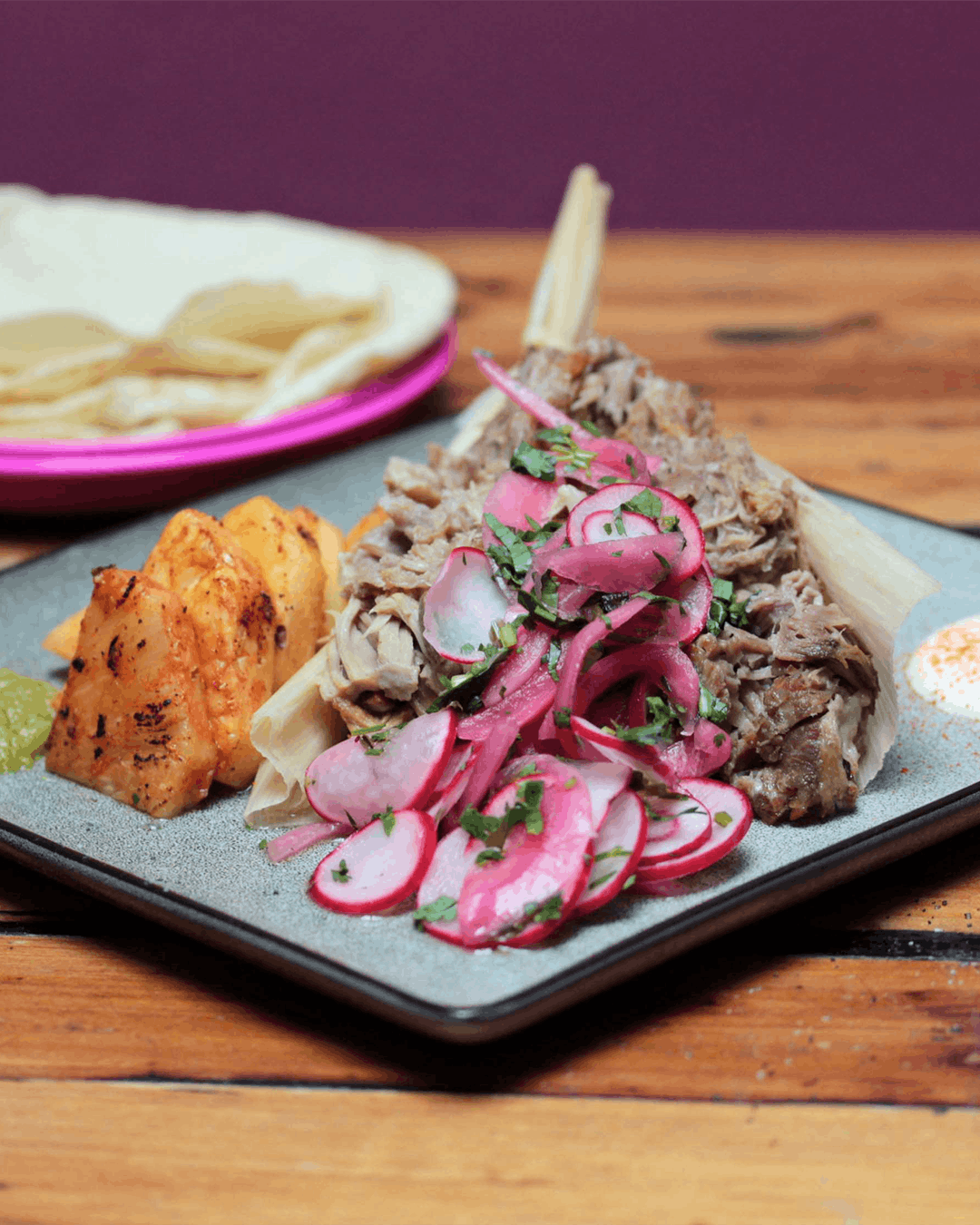 a plate of food sitting on top of a wooden cutting board