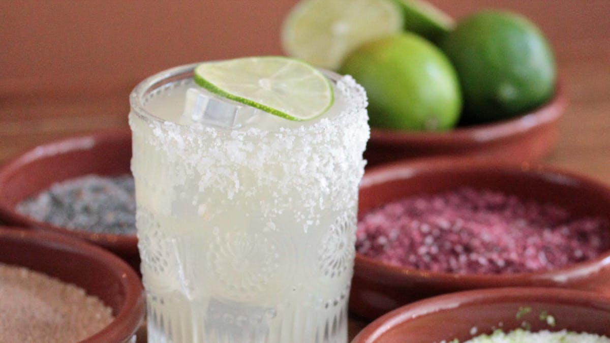 glass of Margarita with salts and bowl of limes