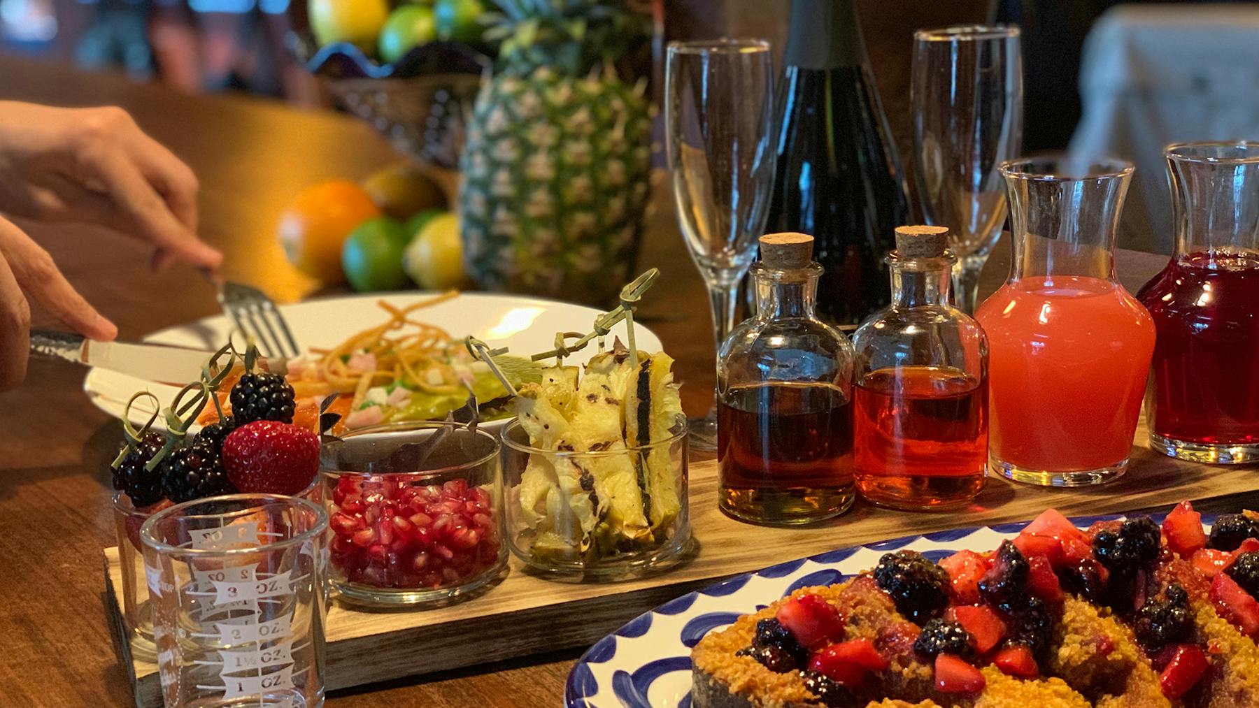 a table topped with plates of food and glasses of wine