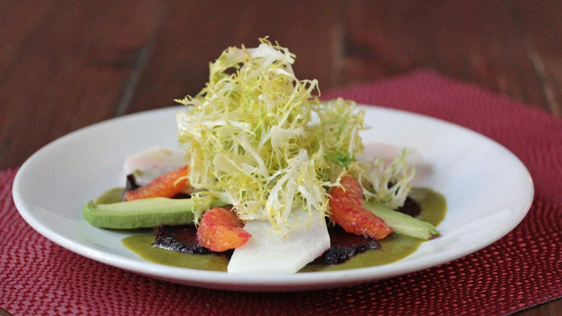 a white plate topped with meat and vegetables