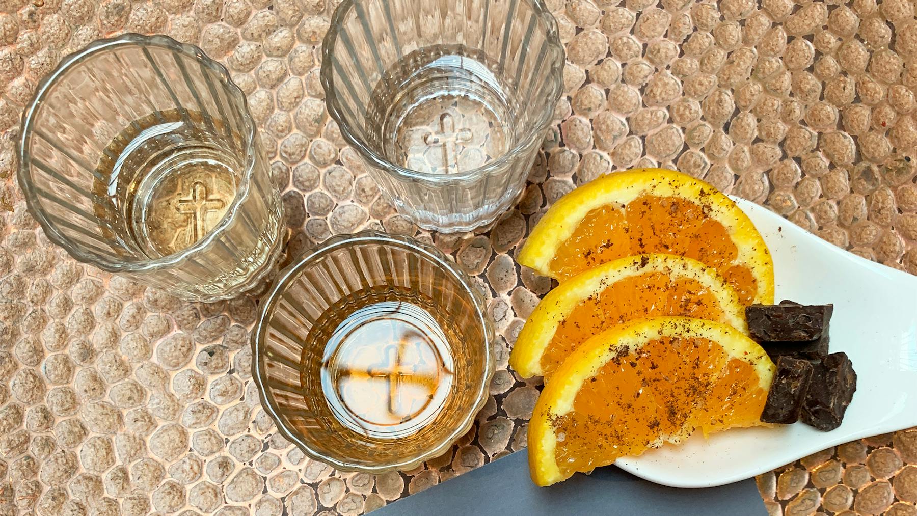 3 small glasses of our Mezcal flights with orange slices and chocolate