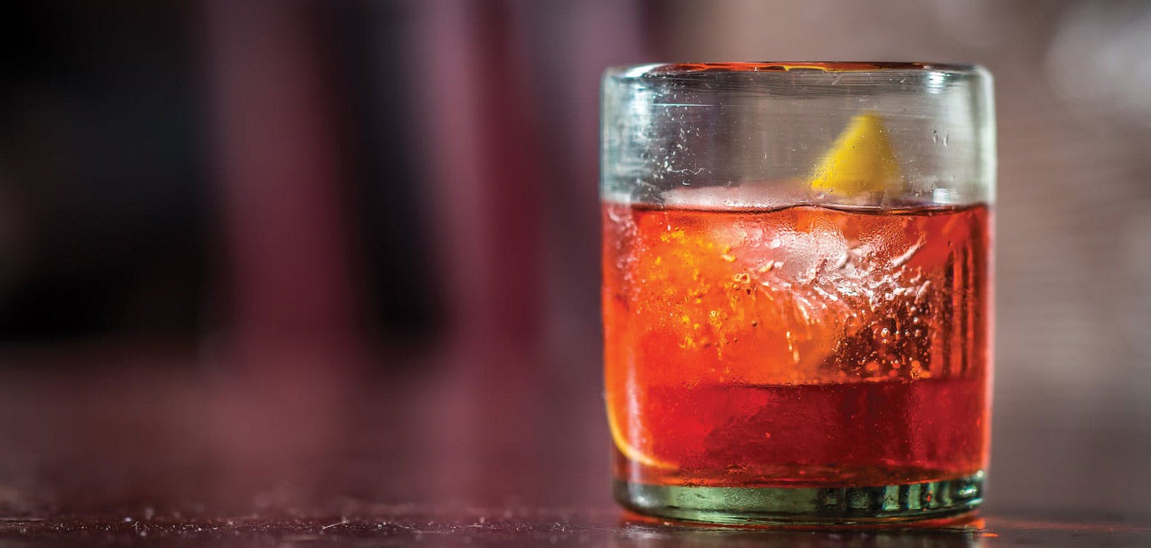 A hand-shaken cocktail with lemon