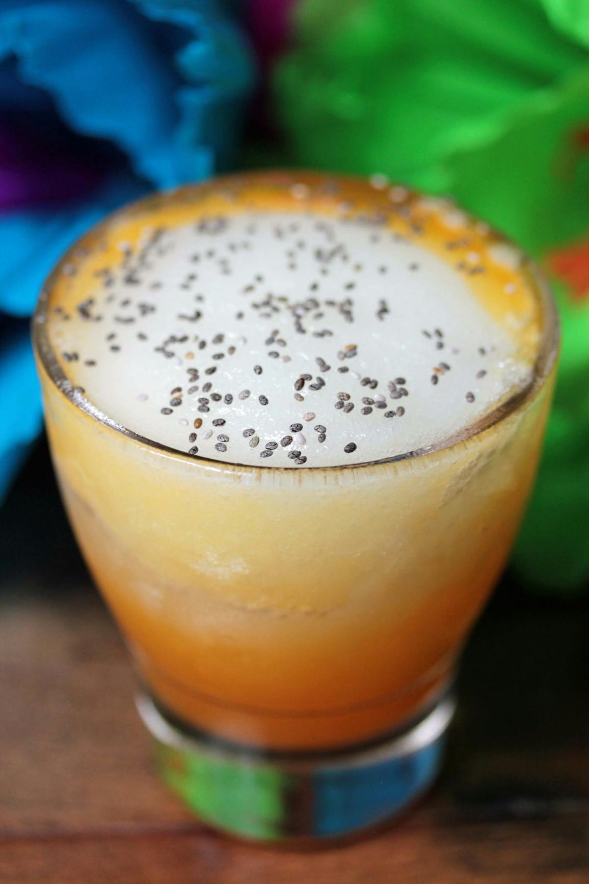 a glass of orange juice next to a cup of coffee