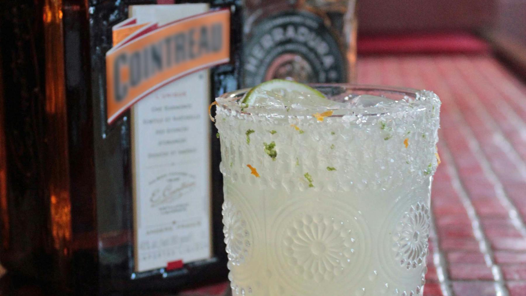 a glass of margarita on top of a table