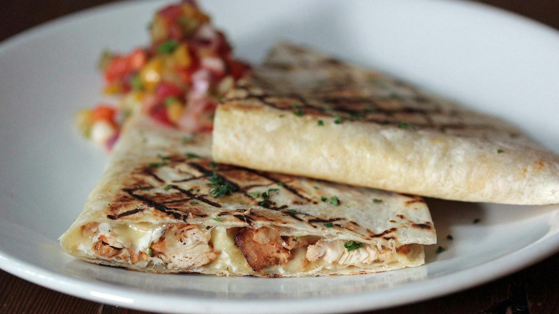 a close up of a plate of food with a slice of pizza