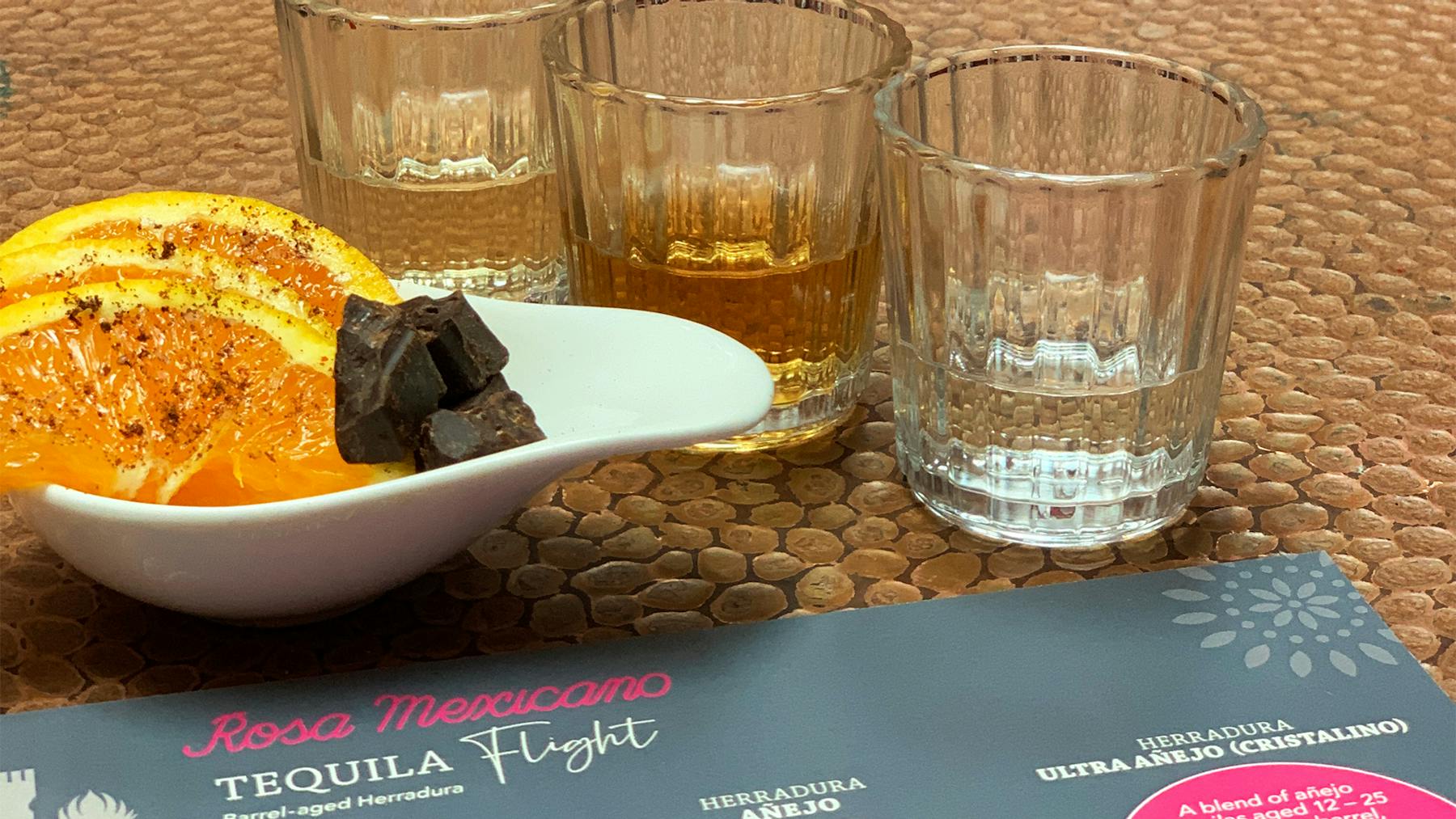 3 small glasses of our Mezcal flights with orange slices and chocolate