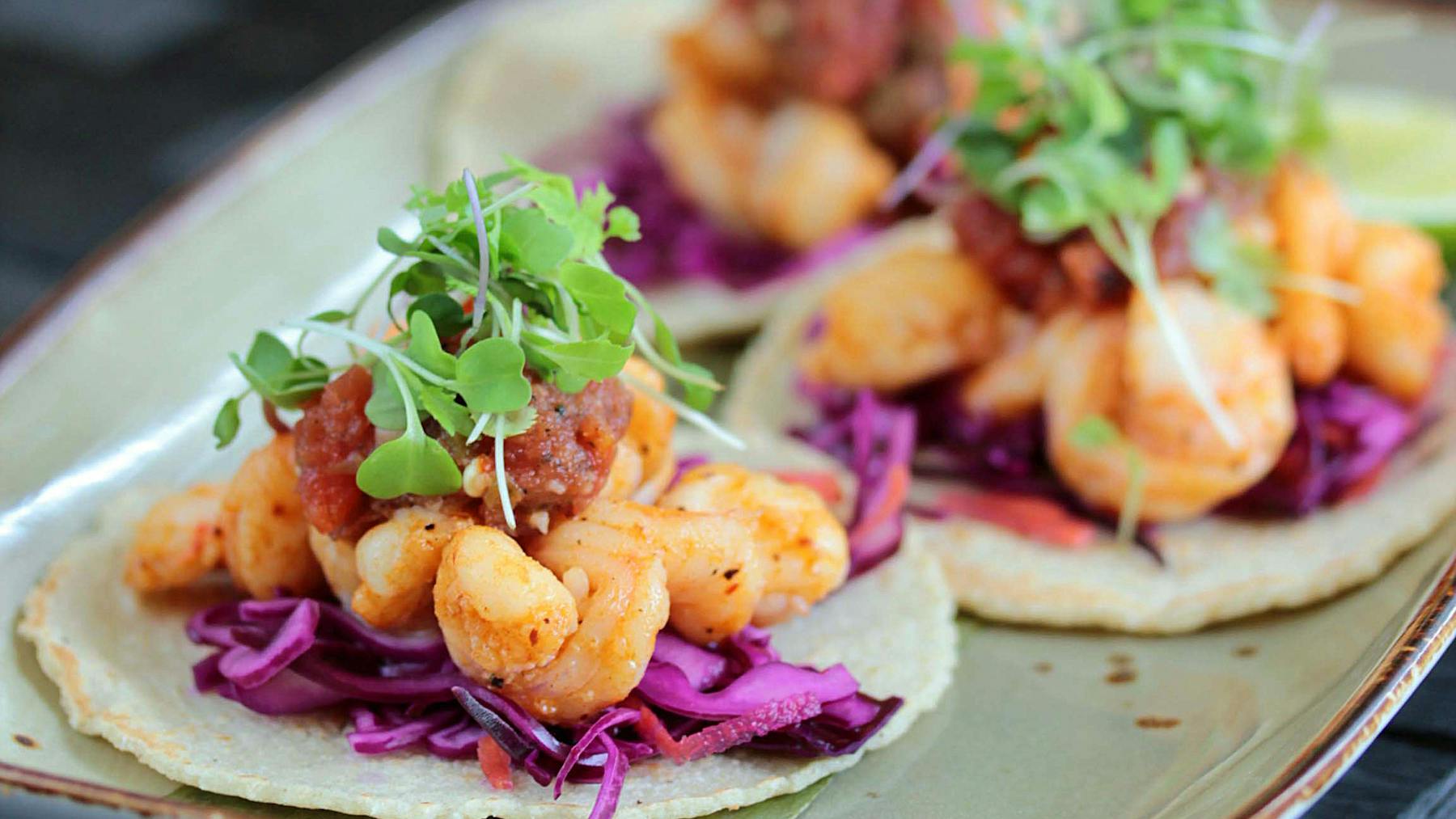 a close up of shrimp tacos