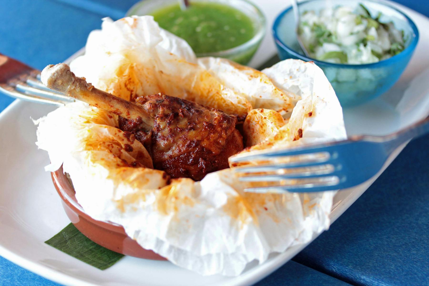 a plate of chicken leg with a fork