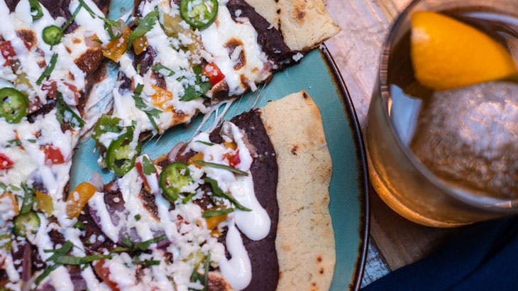 pizza and a cocktail on a table