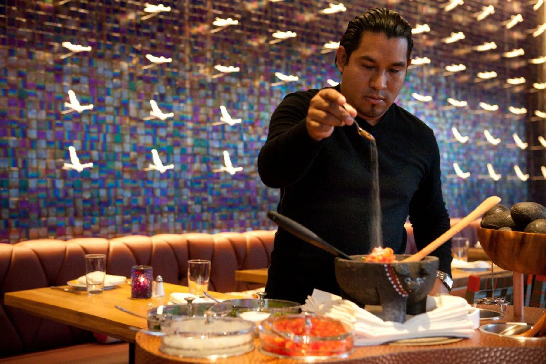 fresh guacamole being made in front of diners