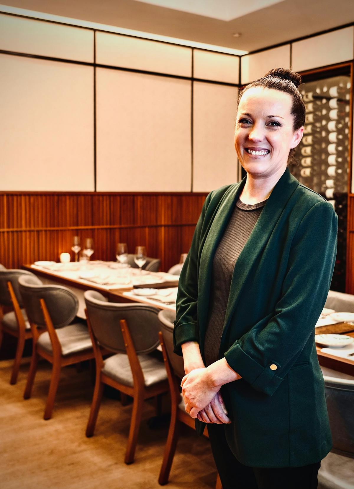 Elena Leeve standing in front of a table