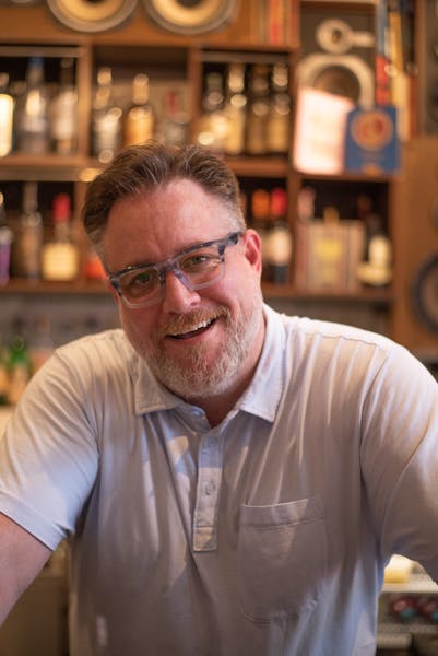 a man in glasses looking at the camera
