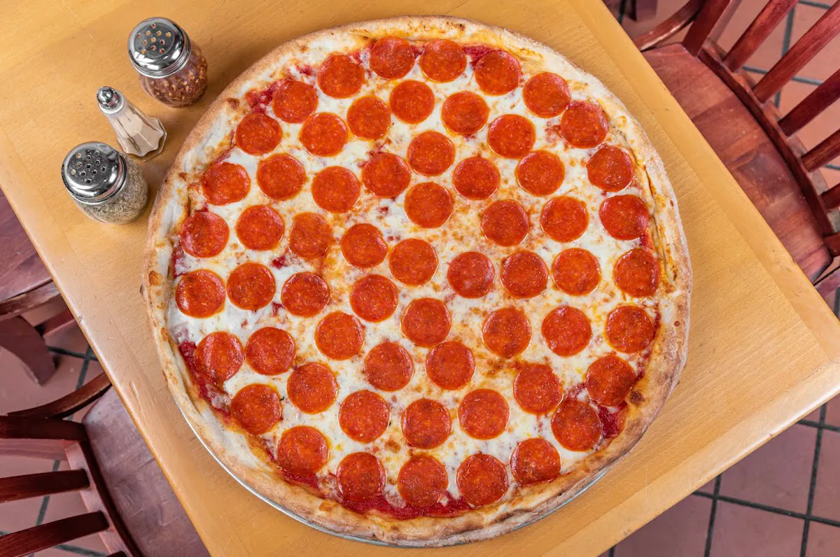 a pizza sitting on top of a wooden table