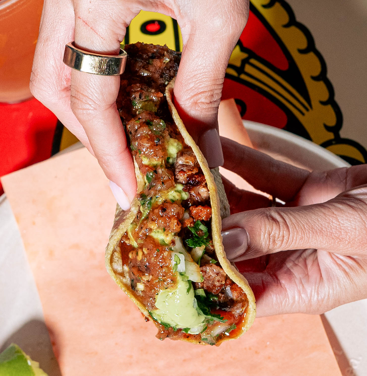 a person holding a slice of pizza