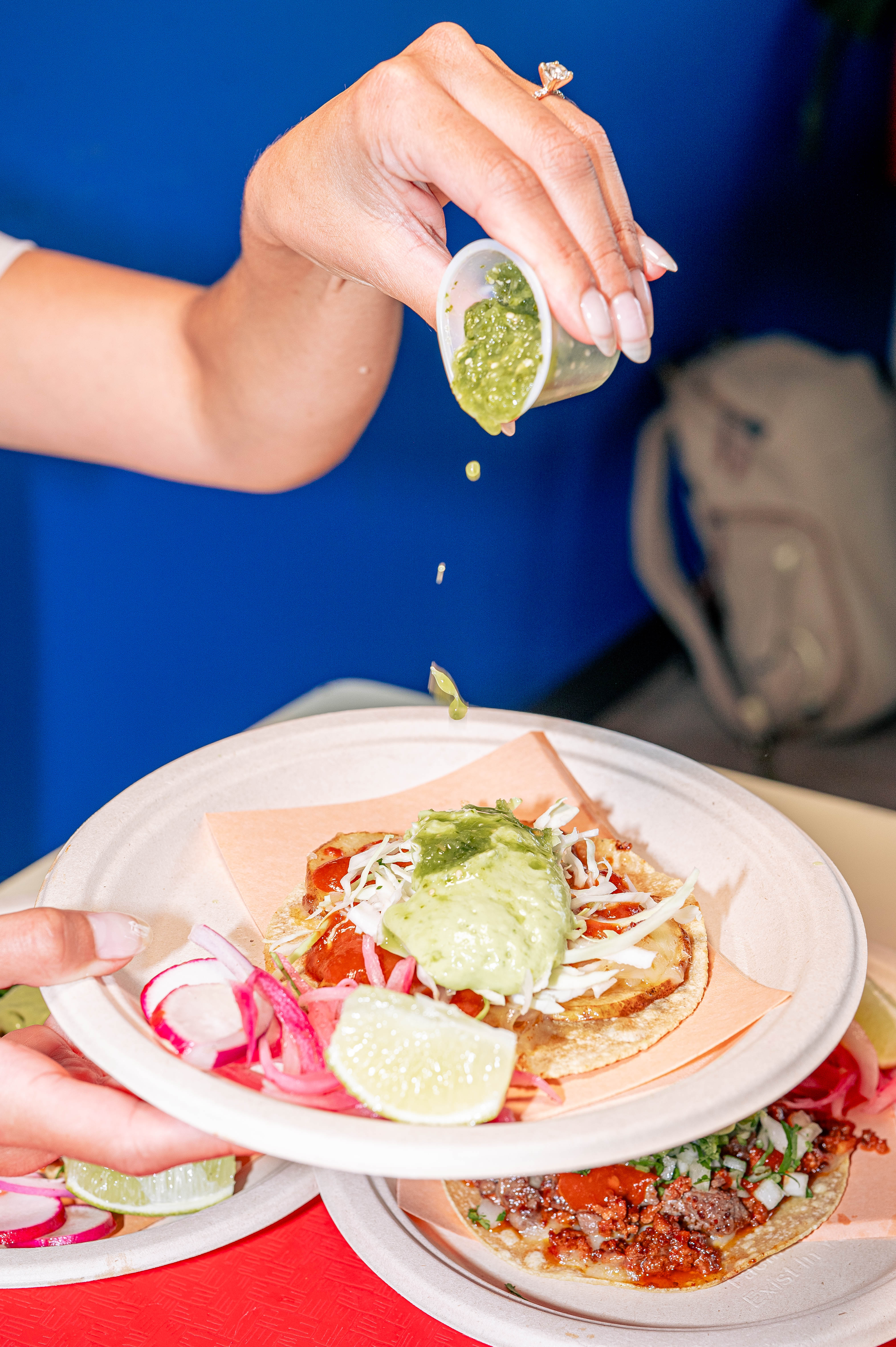 a person sitting at a table with a plate of food
