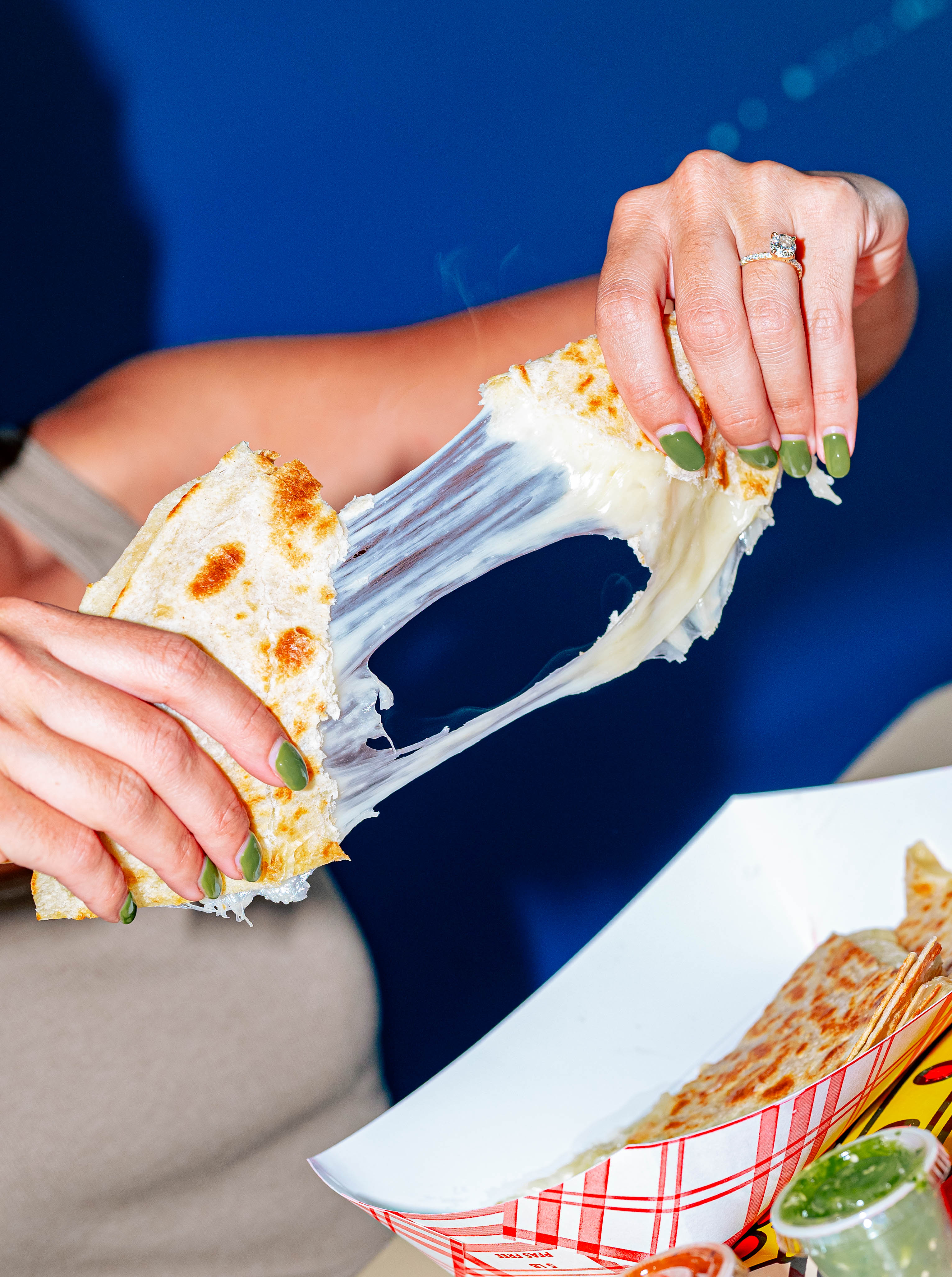 a hand holding a piece of food