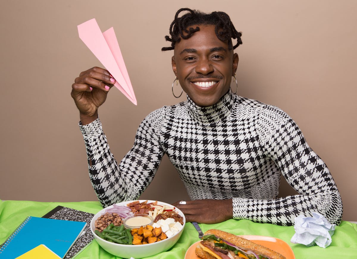 Lazarus Lynch sitting at a table with a plate of food