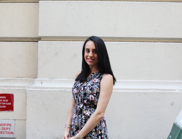 a woman standing in front of a building