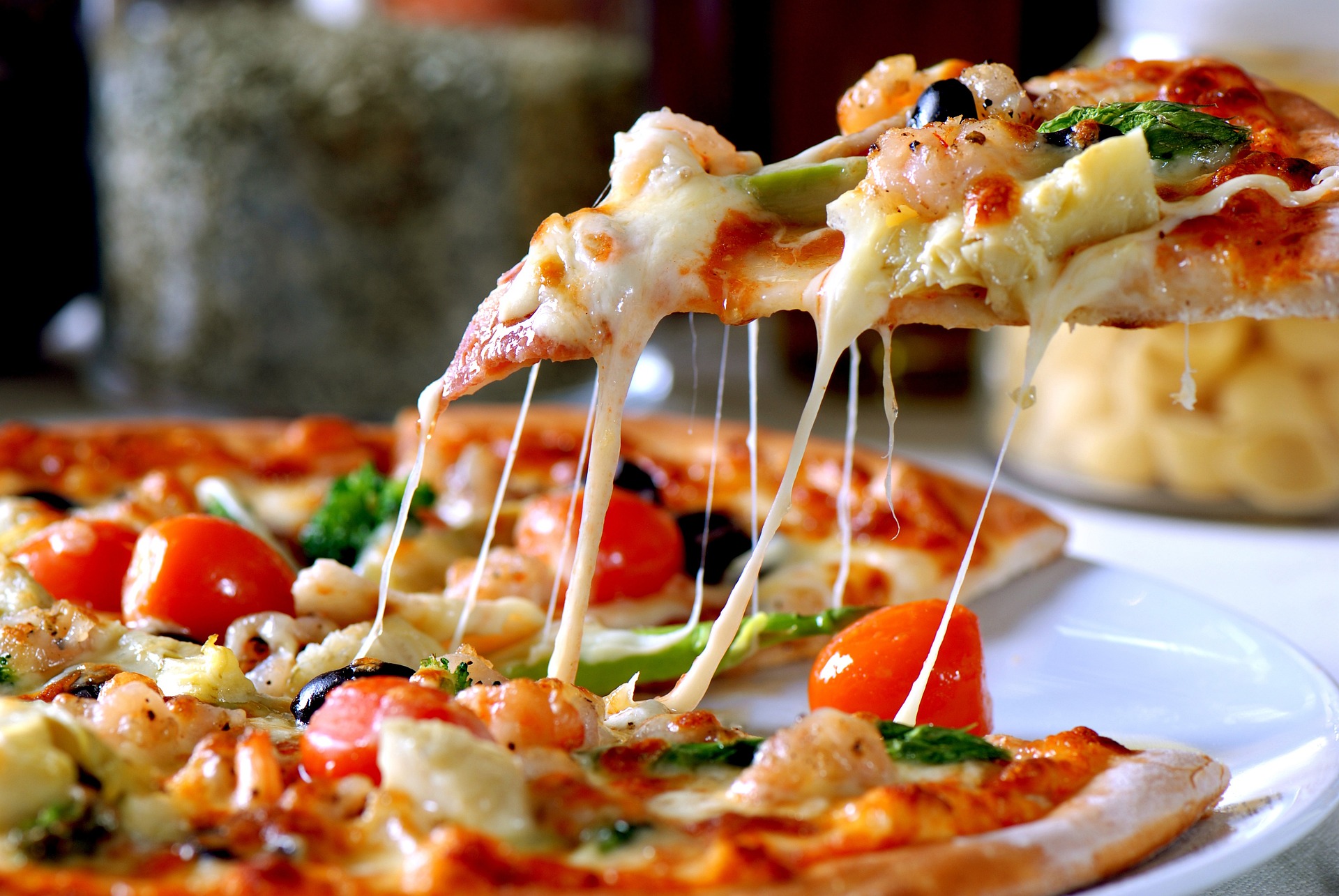 a close up of a plate of food with a slice of pizza
