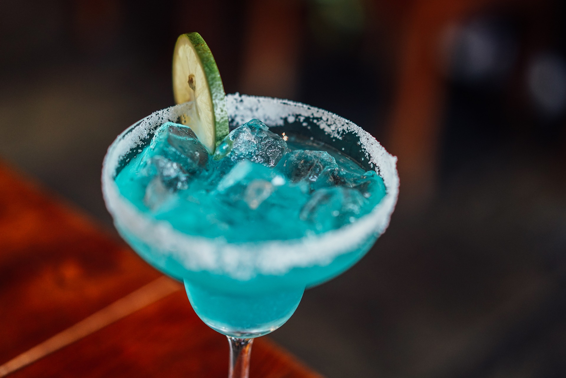 a glass with a blue cake is sitting on a table