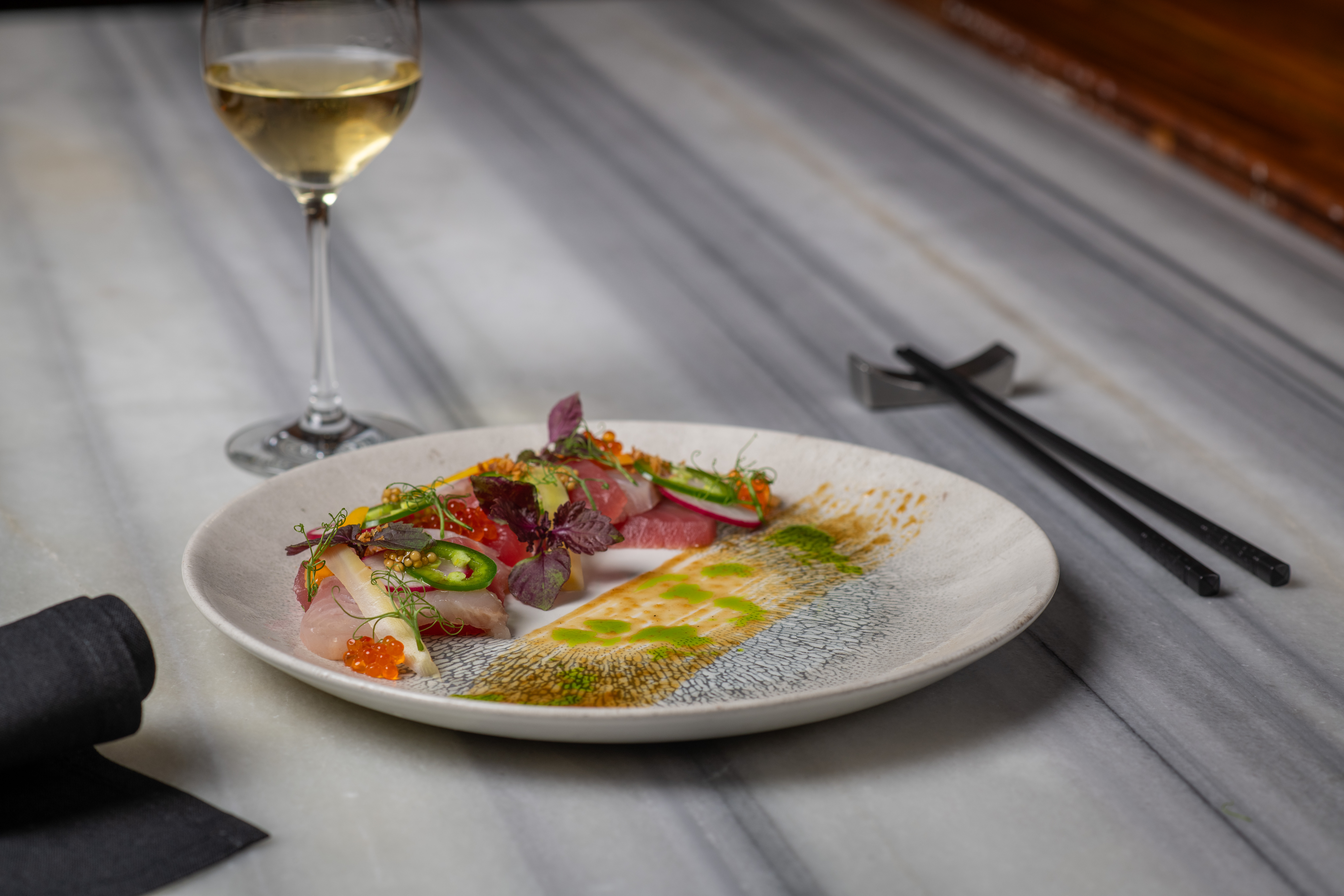 a plate of food and a glass of wine