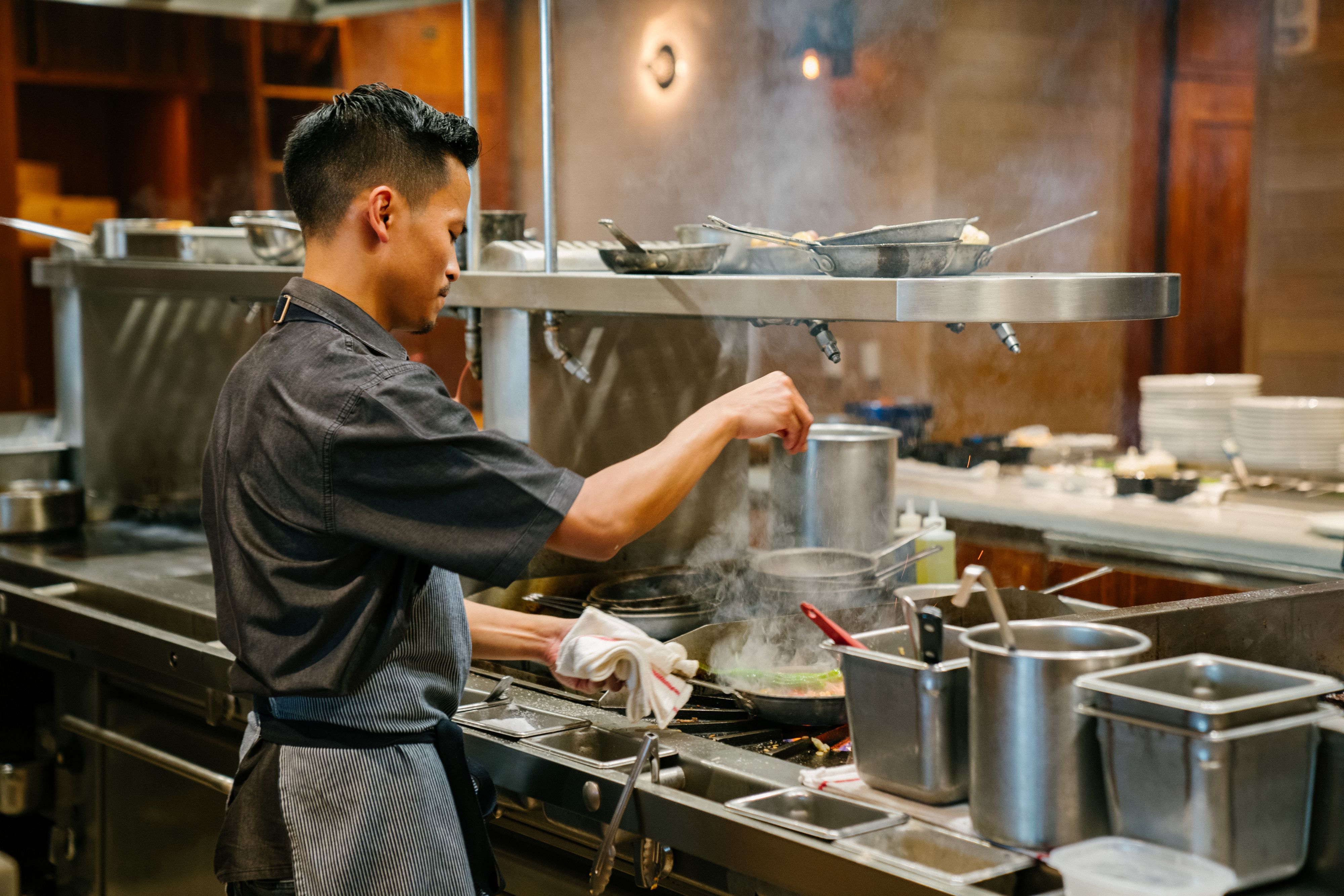 a man cooking in a kitchen preparing food