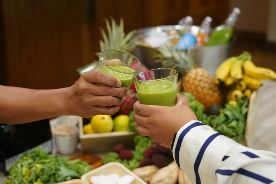 a person holding a bowl of salad