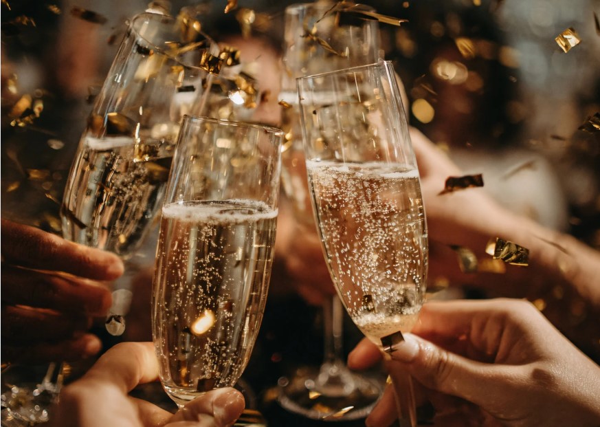 hands toasting glass champagne