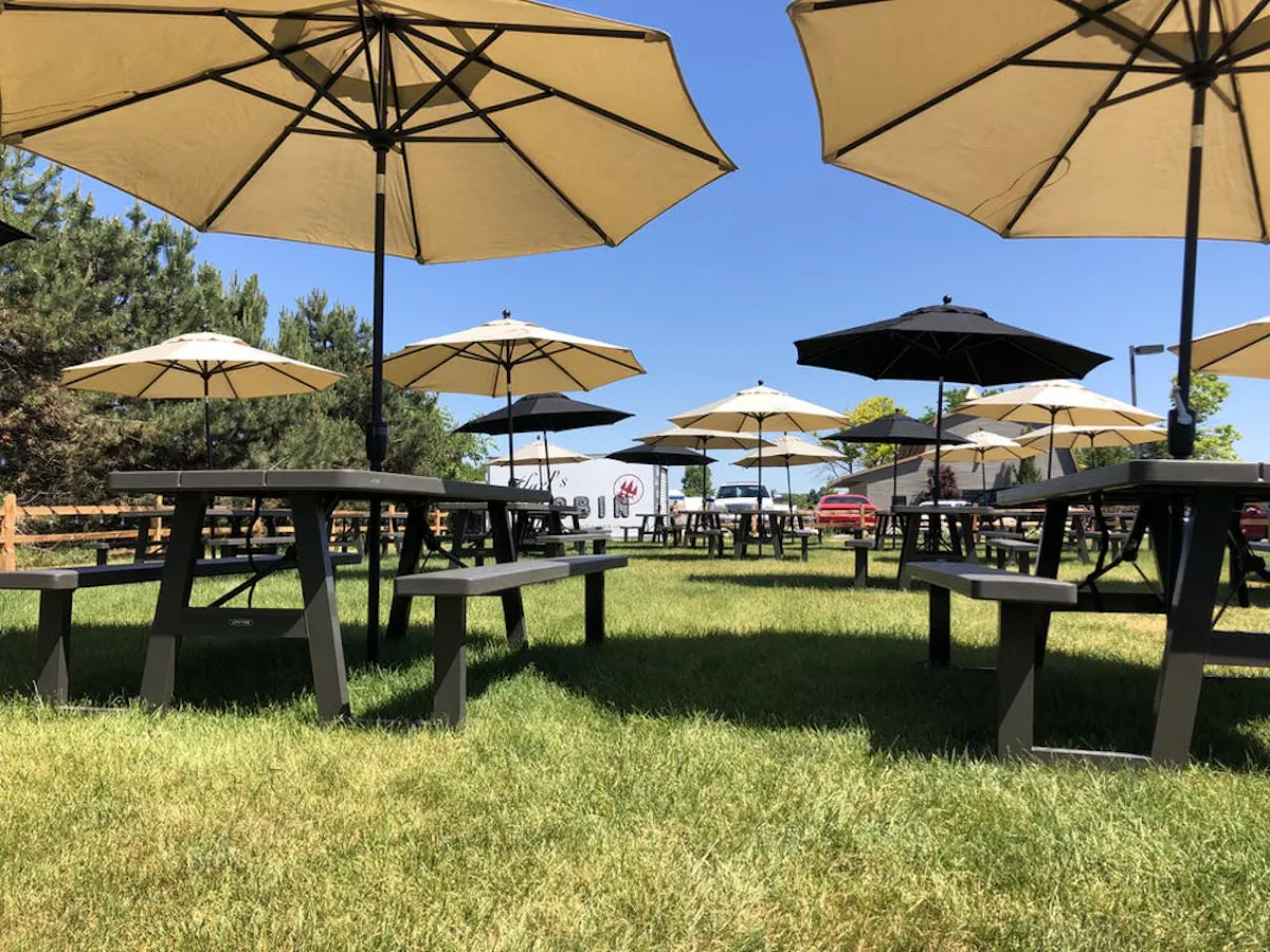 a group of lawn chairs sitting on top of an open umbrella