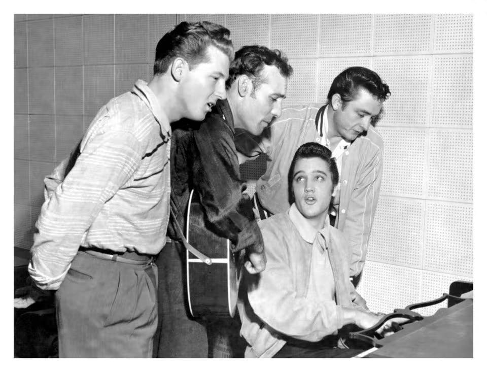 Jerry Lee Lewis, Elvis Presley standing around each other