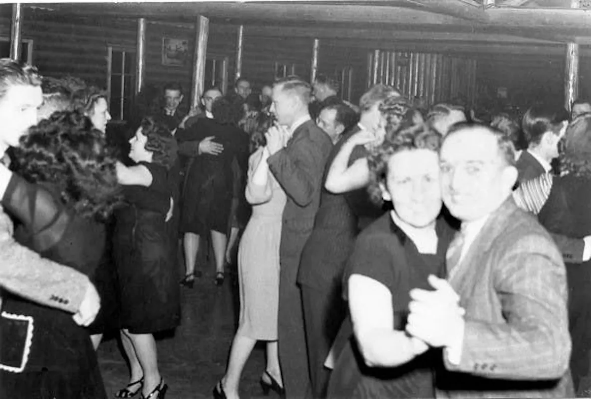 A group of people dancing in the tavern