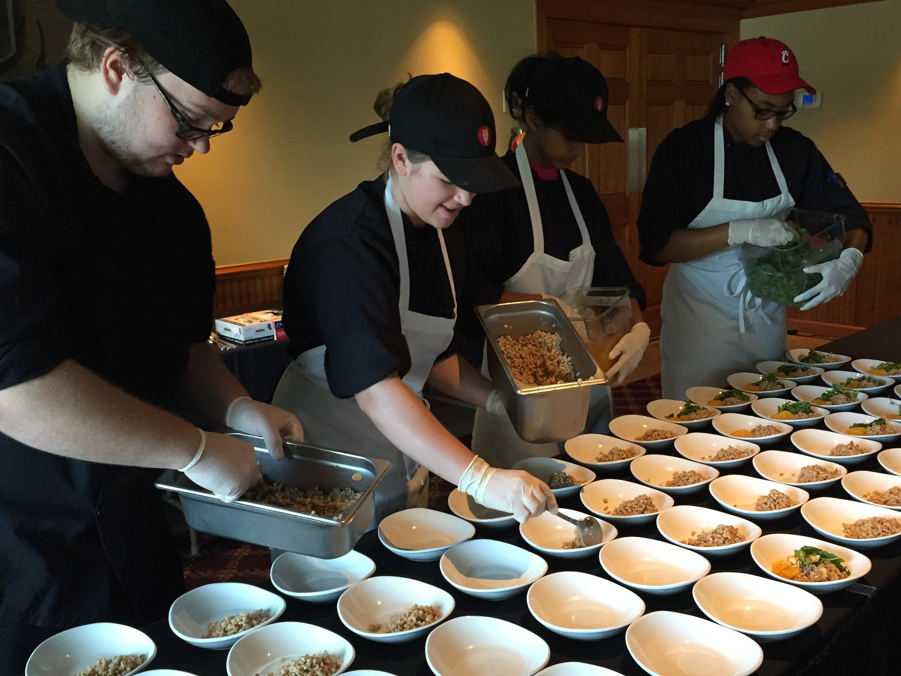 a group of people preparing food on a table
