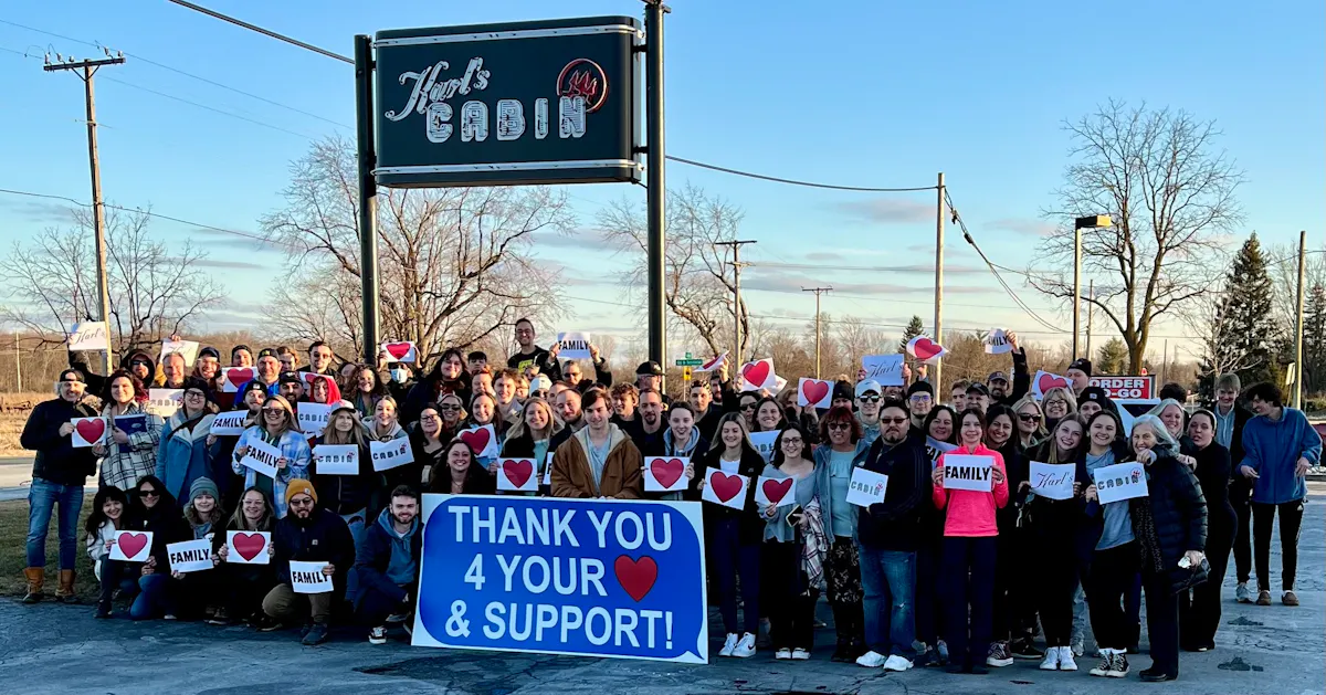 a group of people holding a sign