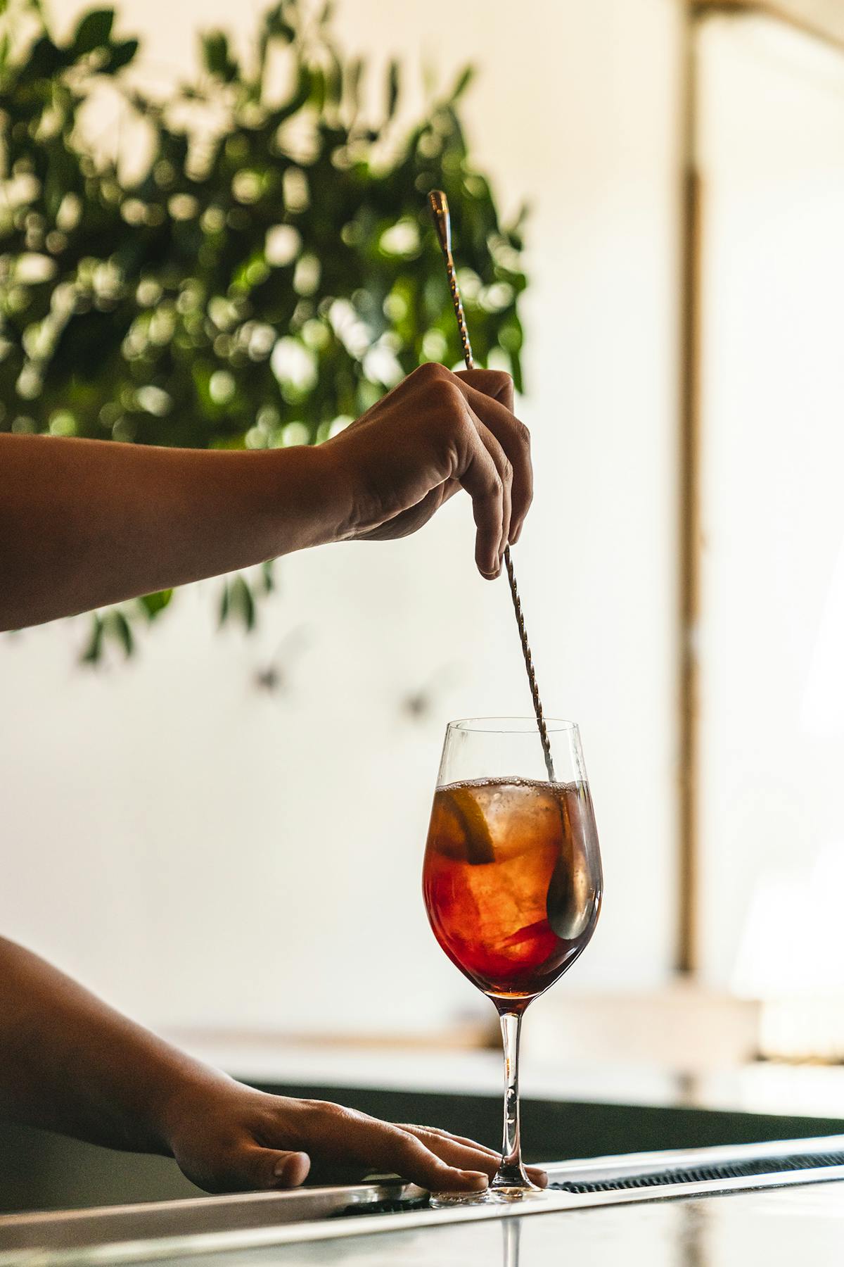 a close up of a person holding a wine glass