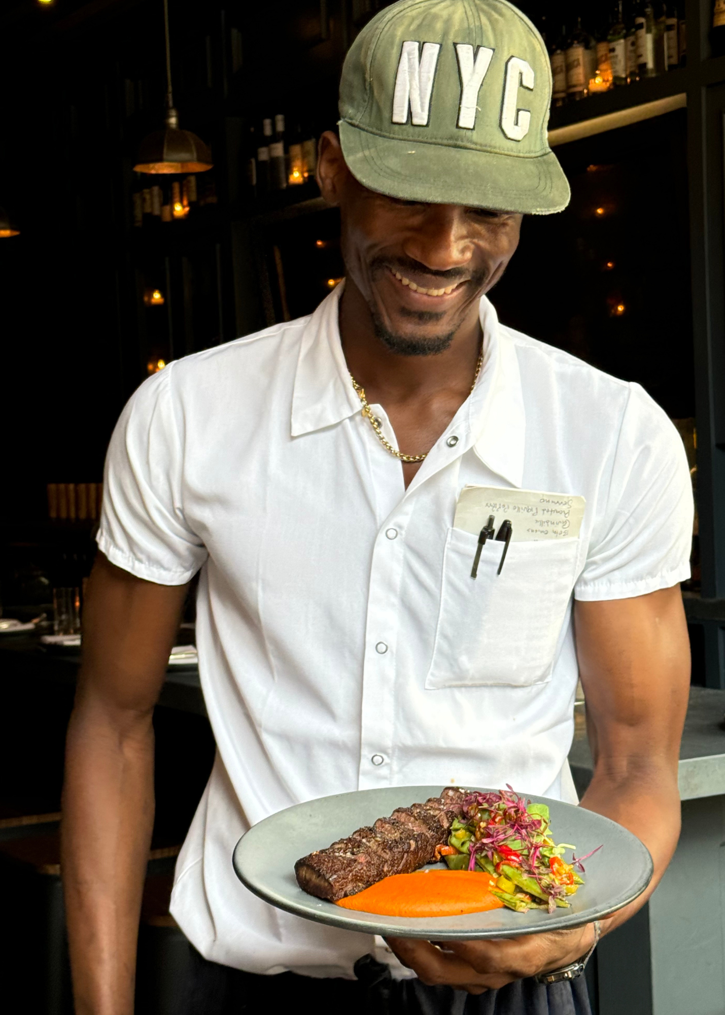 chef holding a plate of bison steak