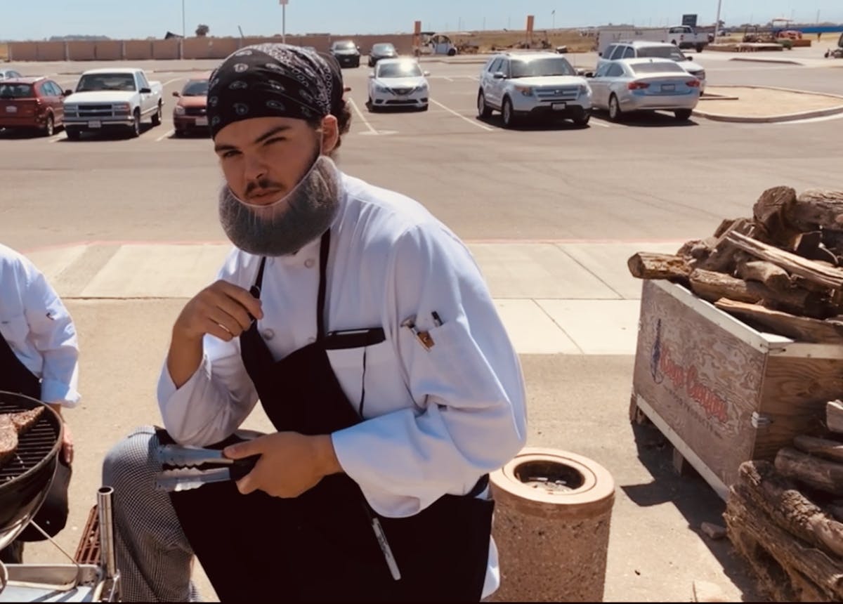a man sitting in a parking lot
