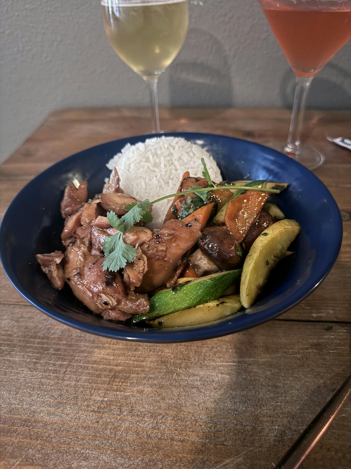 a plate of food and a glass of wine