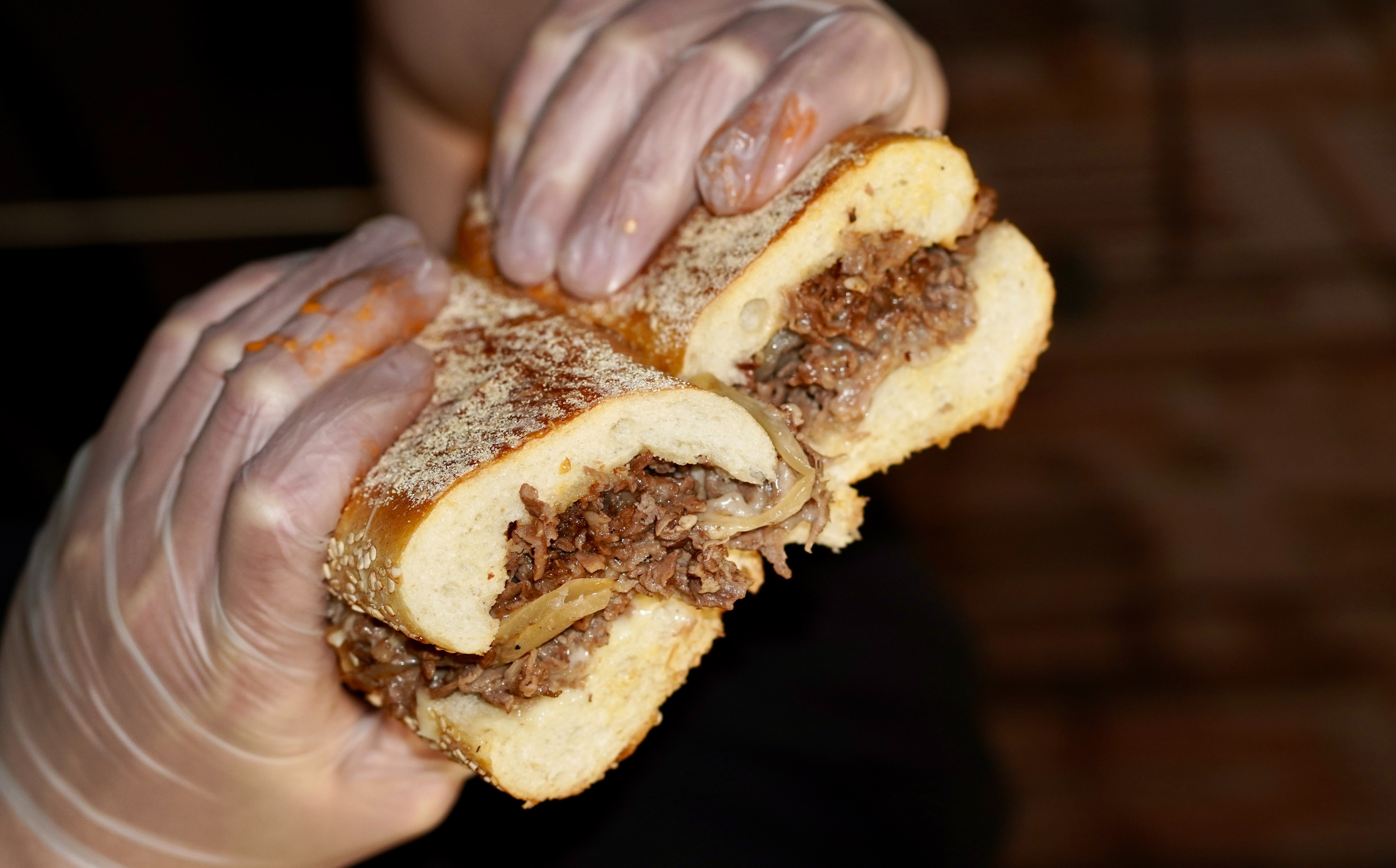 a close up of a person holding a piece of bread