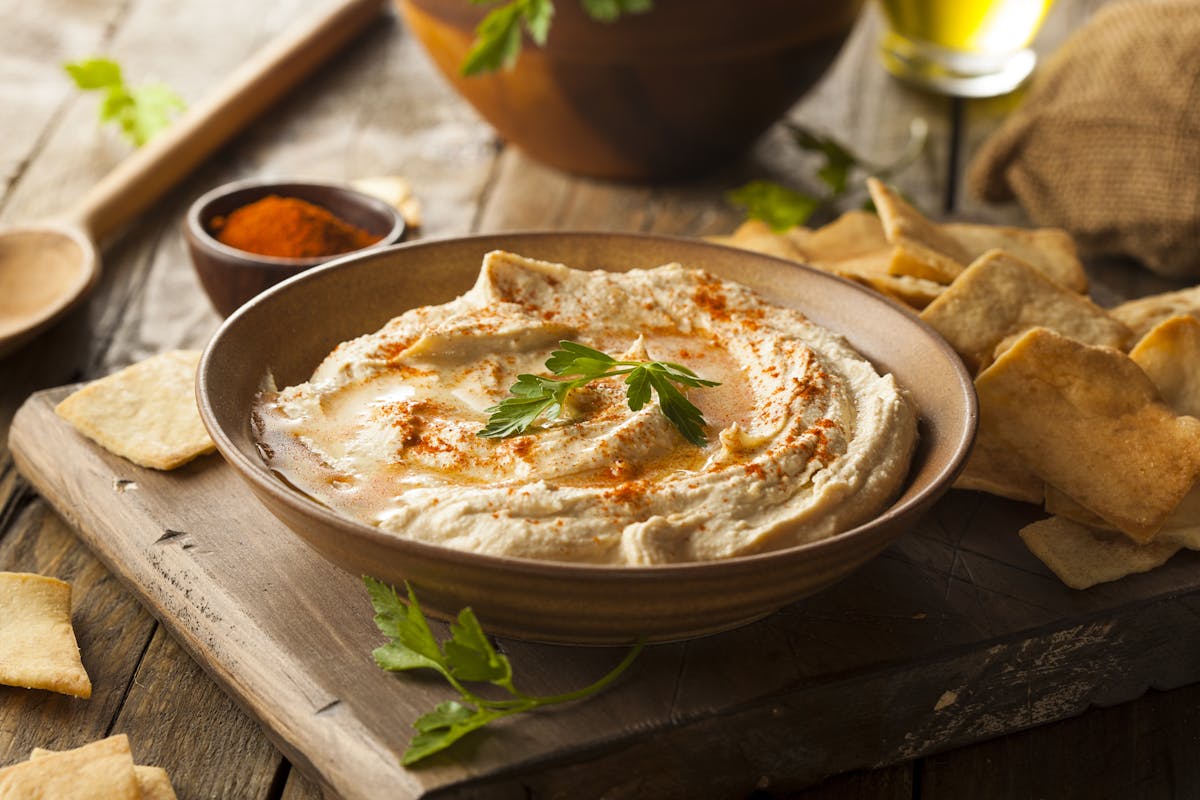 a bowl of food sitting on top of a wooden table