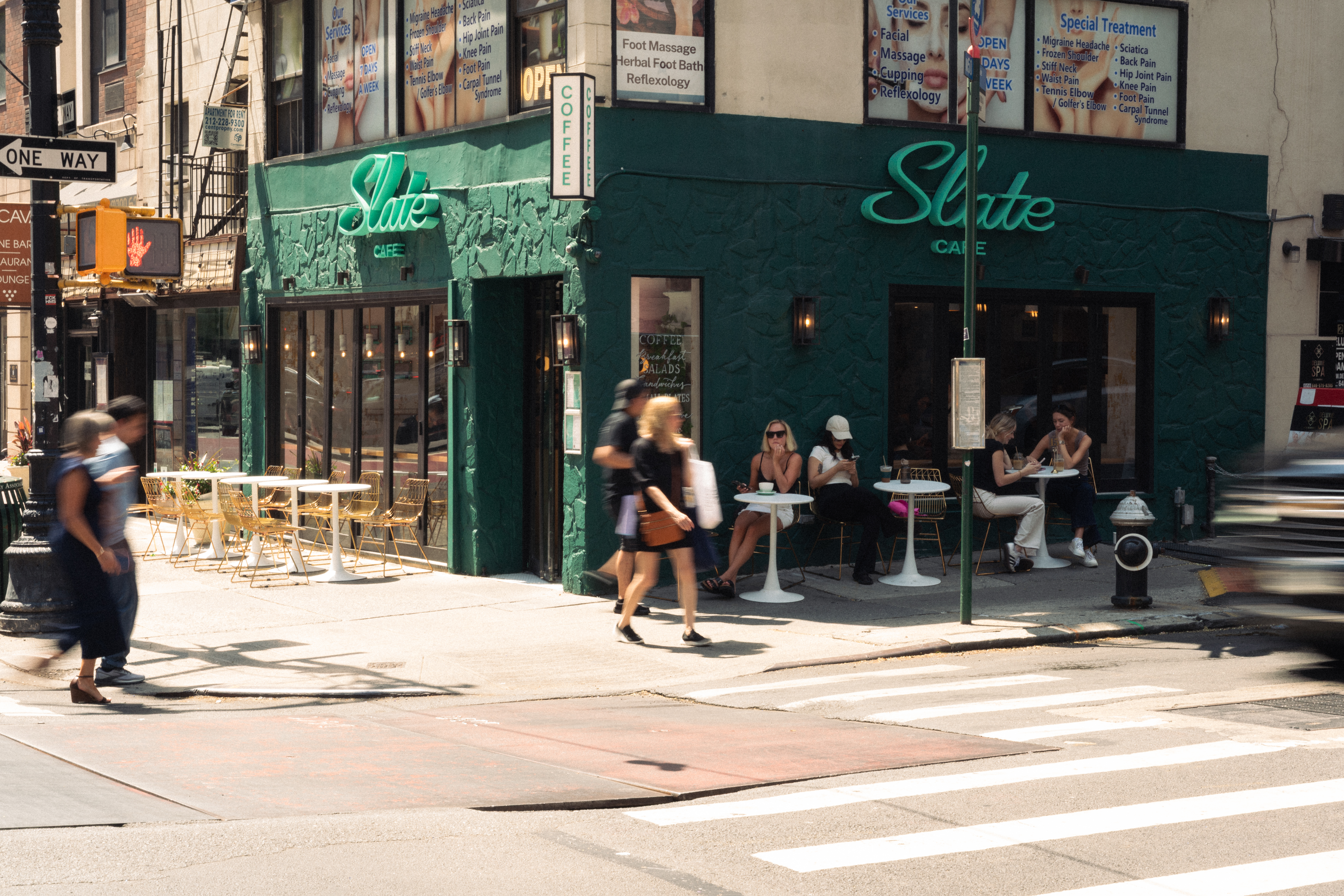 a close up of a front store and people walking