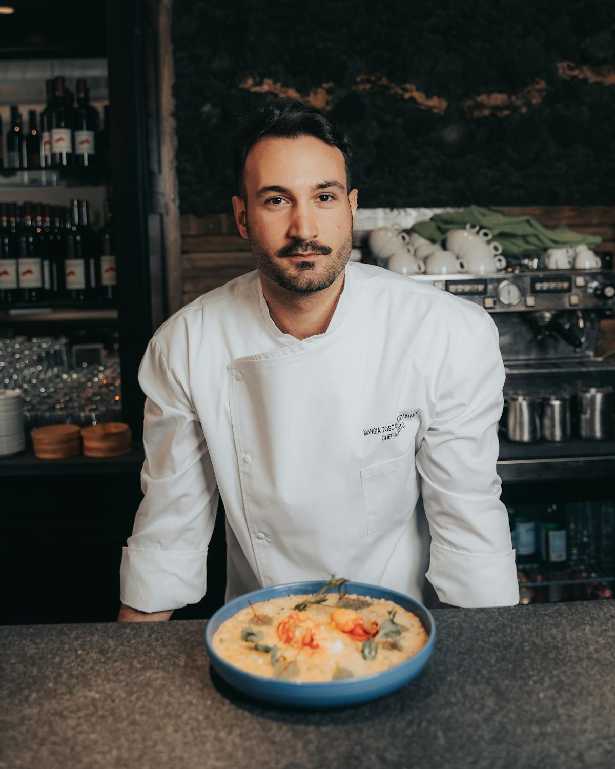 a man standing in front of a table