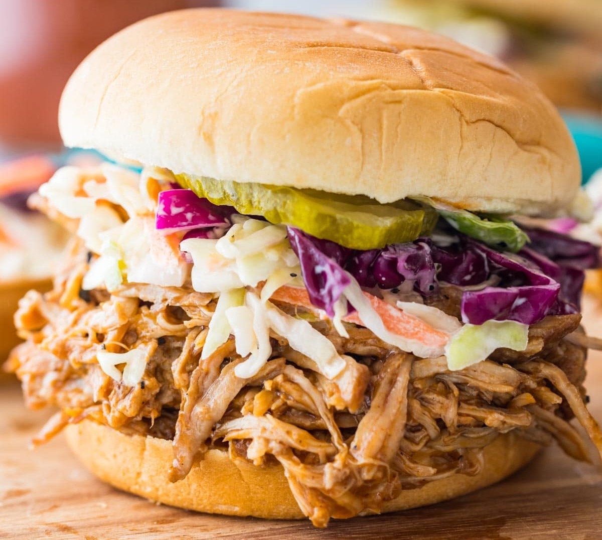 a close up of a sandwich sitting on top of a pile of fries