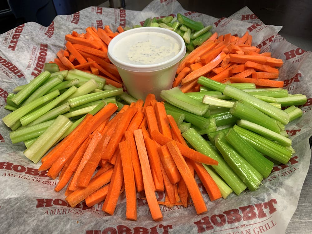 a carrot and a knife on a cutting board