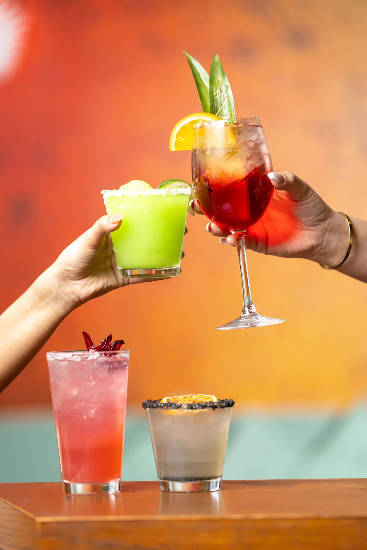 a group of hands holding drinks