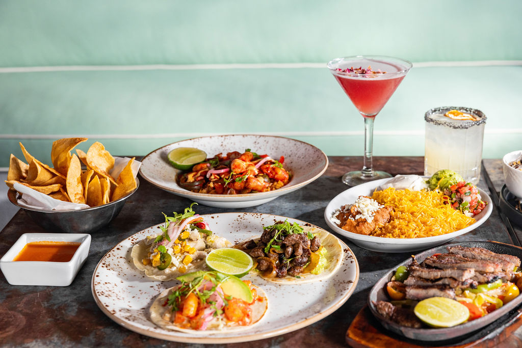 a table with plates of food and drinks