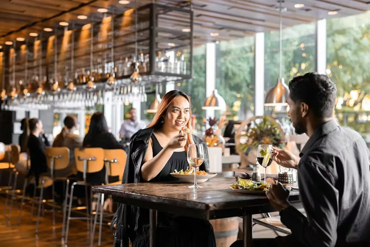 a man and woman eating at a restaurant