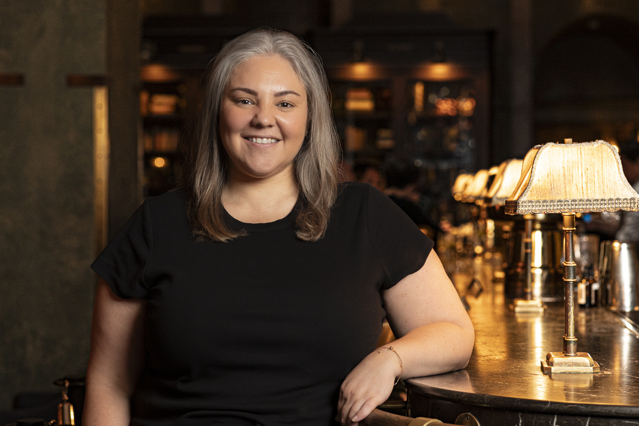a woman standing in front of a restaurant