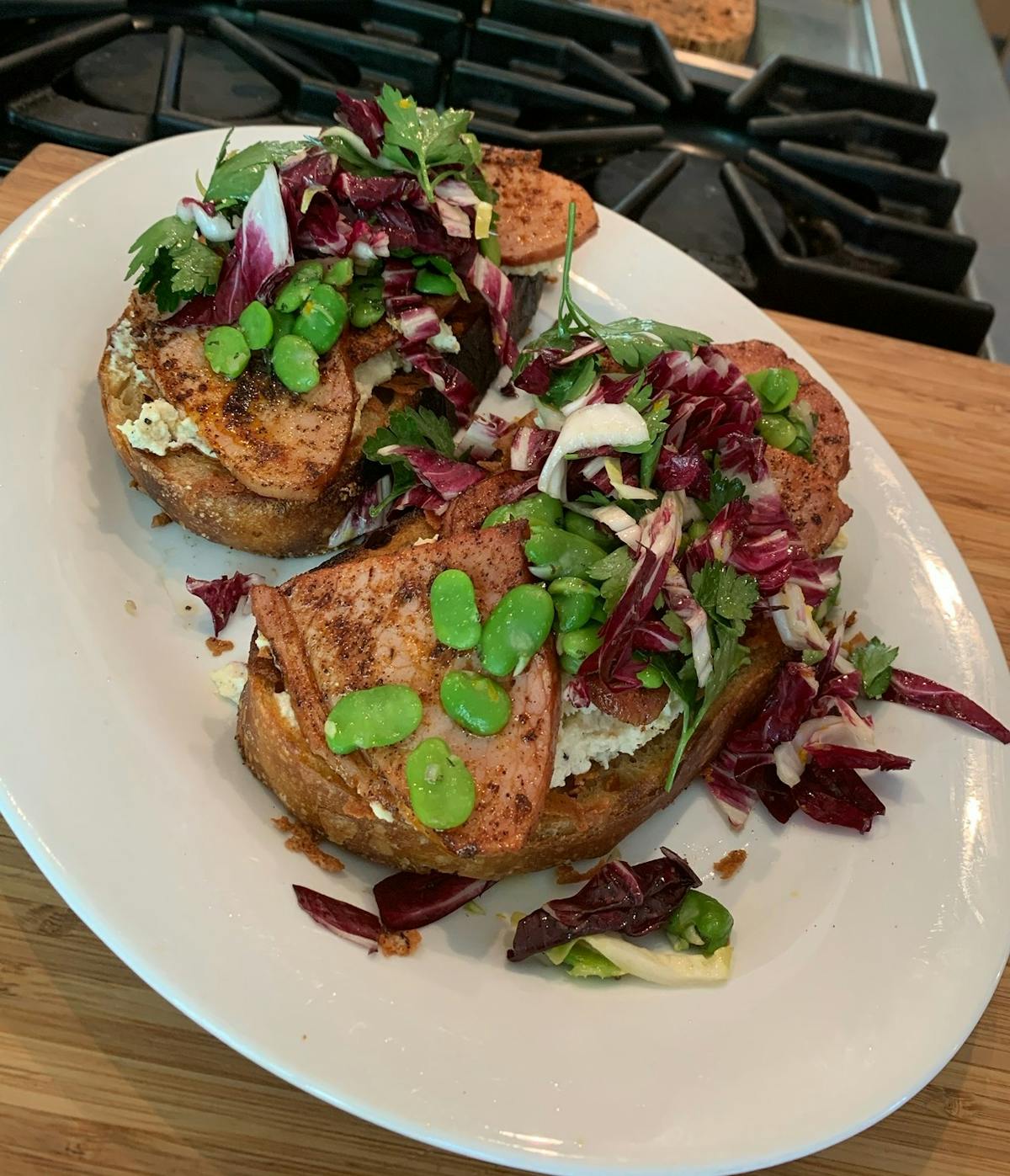 a white plate topped with meat and vegetables