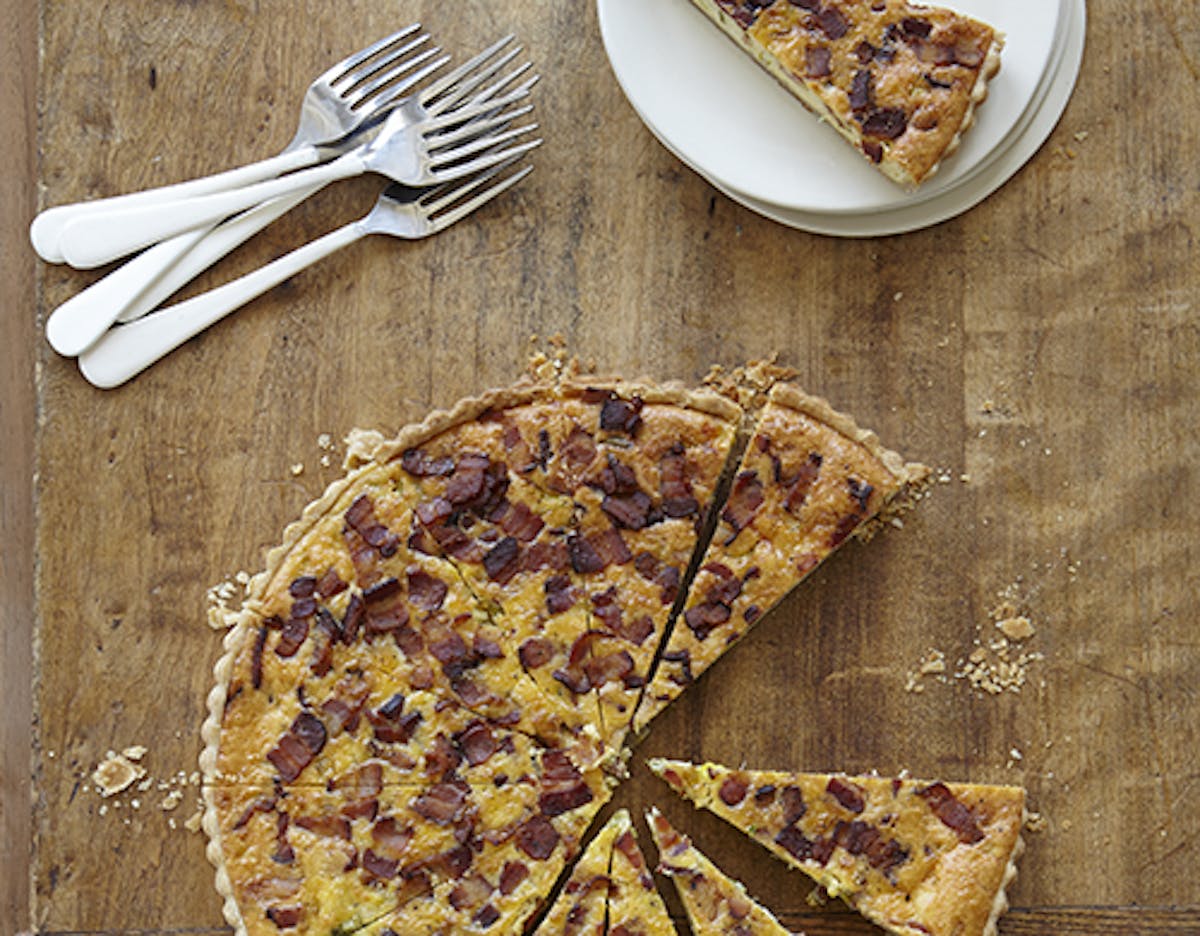 A slice of Pie on a wooden board.